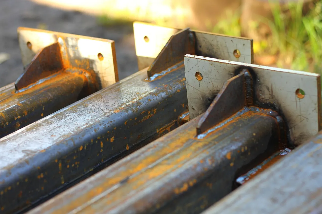 Cut steel plates and gussets on fabricated steel beams
